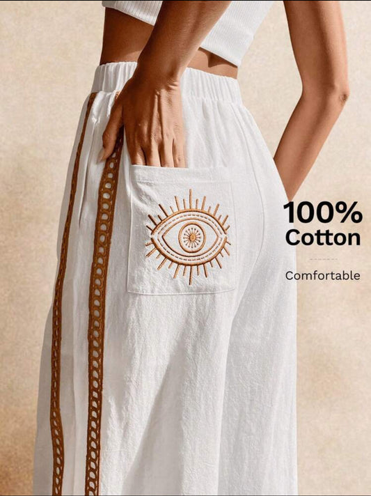 🤍 Calça Boho Branca Bordado de Olho Grego – Conforto, Proteção e Estilo